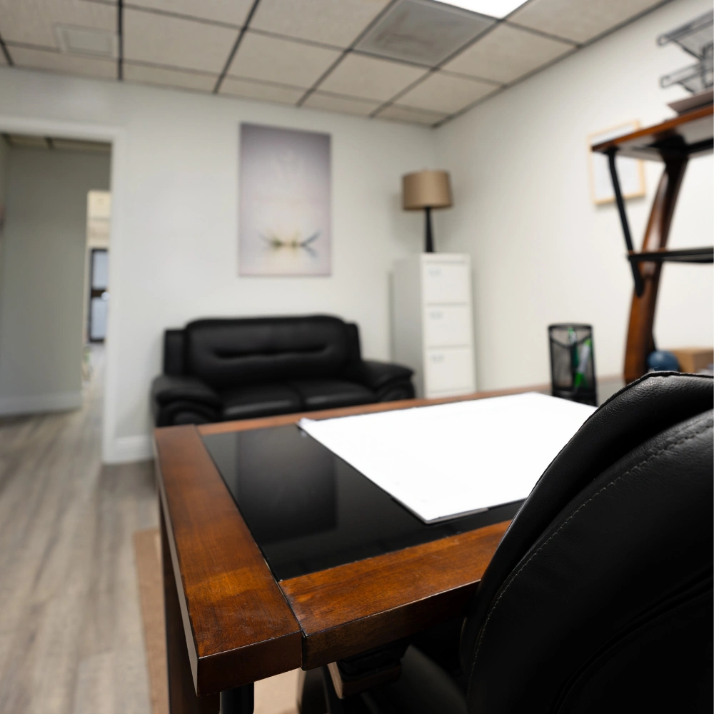 A desk and chairs where therapists work with patients